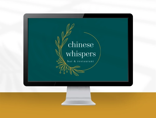 Computer screen showing a logo design with a floral detail