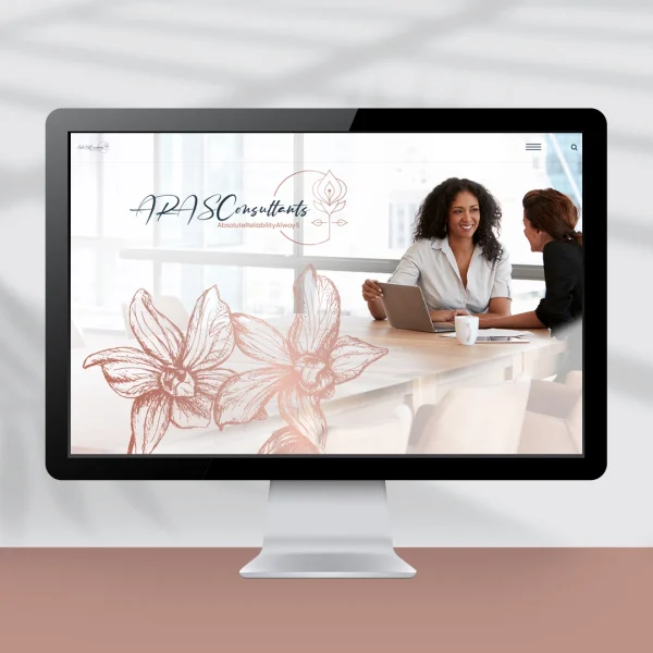 Computer screen showing a website design showing corporate women sitting at a table